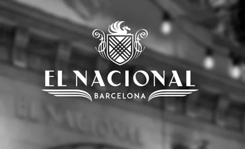 Illuminated interior of the El Nacional culinary multi-space at the end of Passatge Maria Canals